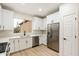 Modern white kitchen with stainless steel appliances and quartz countertops at 10802 E Secret Canyon Rd, Gold Canyon, AZ 85118