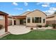 Landscaped backyard with patio, and lush green grass at 10802 E Secret Canyon Rd, Gold Canyon, AZ 85118