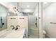 Modern bathroom with double vanity, marble counters, and a walk-in shower at 10802 E Secret Canyon Rd, Gold Canyon, AZ 85118