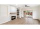 Living room with fireplace, sliding glass doors, and wood shelving at 10802 E Secret Canyon Rd, Gold Canyon, AZ 85118