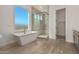 Luxurious bathroom with soaking tub, walk-in shower, and modern fixtures at 13637 W Hackamore Dr, Peoria, AZ 85383