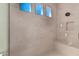 Large walk-in shower with built-in bench and multiple shower heads at 13637 W Hackamore Dr, Peoria, AZ 85383