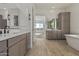 Main bathroom with double vanities, soaking tub, and modern finishes at 13637 W Hackamore Dr, Peoria, AZ 85383