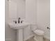 Modern bathroom with pedestal sink and toilet at 13637 W Hackamore Dr, Peoria, AZ 85383