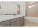 Modern bathroom with a soaking tub and quartz vanity at 13637 W Hackamore Dr, Peoria, AZ 85383