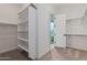 Spacious walk-in closet with built-in shelves and hanging rods at 13637 W Hackamore Dr, Peoria, AZ 85383