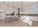 Modern kitchen with white cabinets, large island, and high-end appliances at 13637 W Hackamore Dr, Peoria, AZ 85383