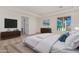 Main bedroom with large bed, window, and ensuite bathroom at 13637 W Hackamore Dr, Peoria, AZ 85383