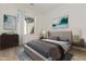 Spacious bedroom with large bed, dresser, and artwork at 13637 W Hackamore Dr, Peoria, AZ 85383