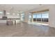 Open floor plan connecting kitchen and living room with sliding glass doors to backyard at 13637 W Hackamore Dr, Peoria, AZ 85383