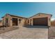 Exterior view of a single-story house with tile roof, two-car garage, and desert landscaping at 13637 W Hackamore Dr, Peoria, AZ 85383