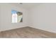 Bright bedroom with wood-look floors and large window at 13637 W Hackamore Dr, Peoria, AZ 85383