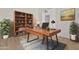 Home office with wood desk, built-in shelving, and plants at 13637 W Hackamore Dr, Peoria, AZ 85383