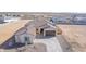 Front exterior view of a single-story home with a tile roof and two-car garage at 13637 W Hackamore Dr, Peoria, AZ 85383