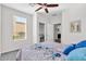 Bedroom with ceiling fan, window, and closet with mirrored doors at 36106 N Desert Tea Dr, San Tan Valley, AZ 85140