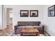 Cozy sitting area with a brown sofa and wood coffee table at 36106 N Desert Tea Dr, San Tan Valley, AZ 85140