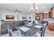 Dining area with a rustic wooden table and chandelier at 36106 N Desert Tea Dr, San Tan Valley, AZ 85140