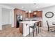 Modern kitchen with island, dark wood cabinets and black appliances at 36106 N Desert Tea Dr, San Tan Valley, AZ 85140