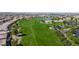 Aerial view of a golf course community with houses, a lake, and lush landscaping at 36106 N Desert Tea Dr, San Tan Valley, AZ 85140