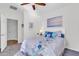 Bright bedroom with ceiling fan, large window, and a comfortable bed at 36106 N Desert Tea Dr, San Tan Valley, AZ 85140