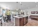 Open kitchen features an island, breakfast bar, and views into the Gathering room at 36106 N Desert Tea Dr, San Tan Valley, AZ 85140