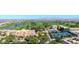 Aerial view of a community clubhouse, tennis courts, and golf course at 36106 N Desert Tea Dr, San Tan Valley, AZ 85140