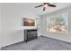 Well-lit bedroom with ceiling fan, large window, and a dresser at 36106 N Desert Tea Dr, San Tan Valley, AZ 85140