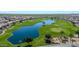 Golf course community with a large lake and residential homes at 36106 N Desert Tea Dr, San Tan Valley, AZ 85140