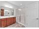 Clean bathroom with a large shower, wood vanity, and linen closet at 36106 N Desert Tea Dr, San Tan Valley, AZ 85140