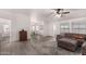 Living room with gray sectional sofa, area rug, and ceiling fan at 11596 W Sierra Dawn Blvd # 269, Surprise, AZ 85378