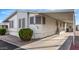 Side view of a mobile home with carport and landscaping at 11596 W Sierra Dawn Blvd # 269, Surprise, AZ 85378