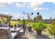 Backyard patio furniture with fire pit and grassy area at 11133 W Cameo Dr, Sun City, AZ 85351