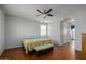 Main bedroom with wood floors, ceiling fan, and ensuite bath access at 4053 S Skyline Ct, Gilbert, AZ 85297