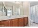 Clean bathroom with double vanity, large mirror and shower/tub combo at 1914 S 235Th Dr, Buckeye, AZ 85326