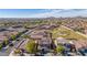 Aerial view of a house in a residential neighborhood with a park nearby at 1914 S 235Th Dr, Buckeye, AZ 85326