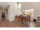 Bright dining room features a wood table with chairs, hardwood floors, and a chandelier at 1914 S 235Th Dr, Buckeye, AZ 85326