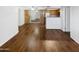 Living room with wood flooring and view into kitchen area at 3601 W Tierra Buena Ln # 228, Phoenix, AZ 85053