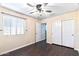 Bedroom with wood flooring, ceiling fan, and double door closet at 18533 W Sanna St, Waddell, AZ 85355