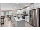 Open concept kitchen with white cabinets and a large island at 2511 W Queen Creek Rd # 205, Chandler, AZ 85248