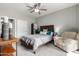 Bedroom with a queen bed, chair, and ceiling fan at 2511 W Queen Creek Rd # 205, Chandler, AZ 85248