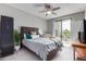 Bright bedroom with a queen bed, balcony access, and ample natural light at 2511 W Queen Creek Rd # 205, Chandler, AZ 85248