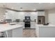 Modern kitchen with white cabinets, stainless steel appliances, and an island at 2511 W Queen Creek Rd # 205, Chandler, AZ 85248
