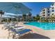 Inviting pool area with blue umbrellas at 2511 W Queen Creek Rd # 205, Chandler, AZ 85248