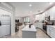 Modern kitchen with white cabinets, island, and stainless steel appliances at 2511 W Queen Creek Rd # 205, Chandler, AZ 85248