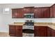 Modern kitchen features stainless steel appliances and granite countertops at 4548 E Carob Dr, Gilbert, AZ 85298
