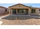 Covered patio and gravel backyard with a rock at 4548 E Carob Dr, Gilbert, AZ 85298