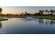 Serene pond with a fountain, overlooking houses and a golf course at 4548 E Carob Dr, Gilbert, AZ 85298