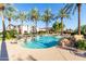 Inviting community pool with palm trees and lounge chairs at 4548 E Carob Dr, Gilbert, AZ 85298