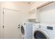 Bright laundry room with washer, dryer and shelving at 4548 E Carob Dr, Gilbert, AZ 85298