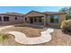 Spacious backyard with covered patio and gravel at 4548 E Carob Dr, Gilbert, AZ 85298